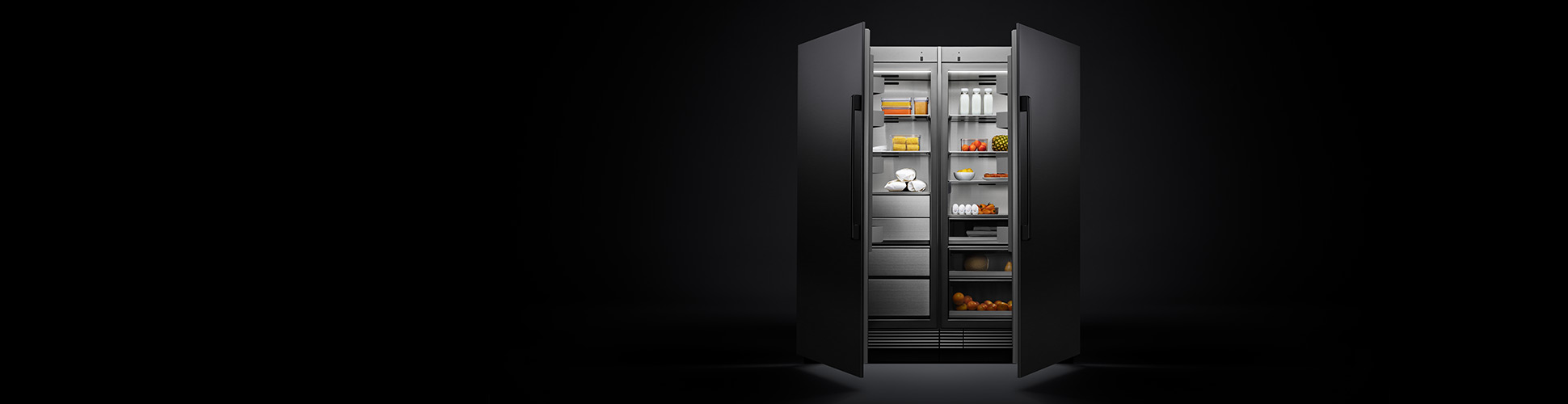 Dacor Refrigerator in dark room with doors open